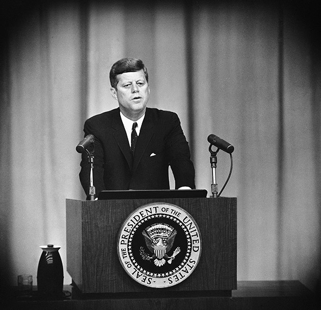 John Kennedy speaking at lecturn.