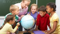 Students looking at a globe