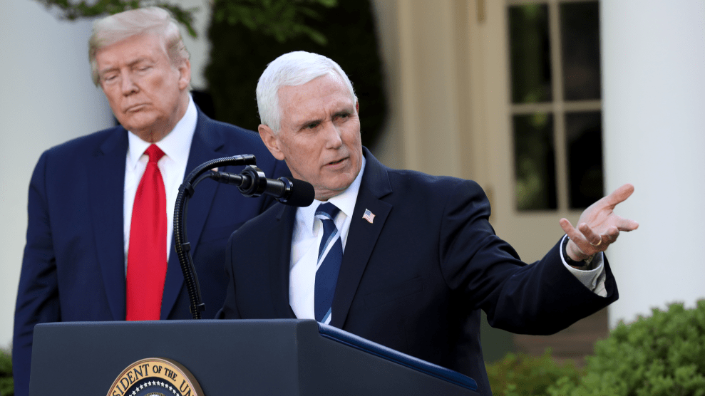 President Trump stands behind Vice President Pence at a podium outdoors in the White House Rose Garden.
