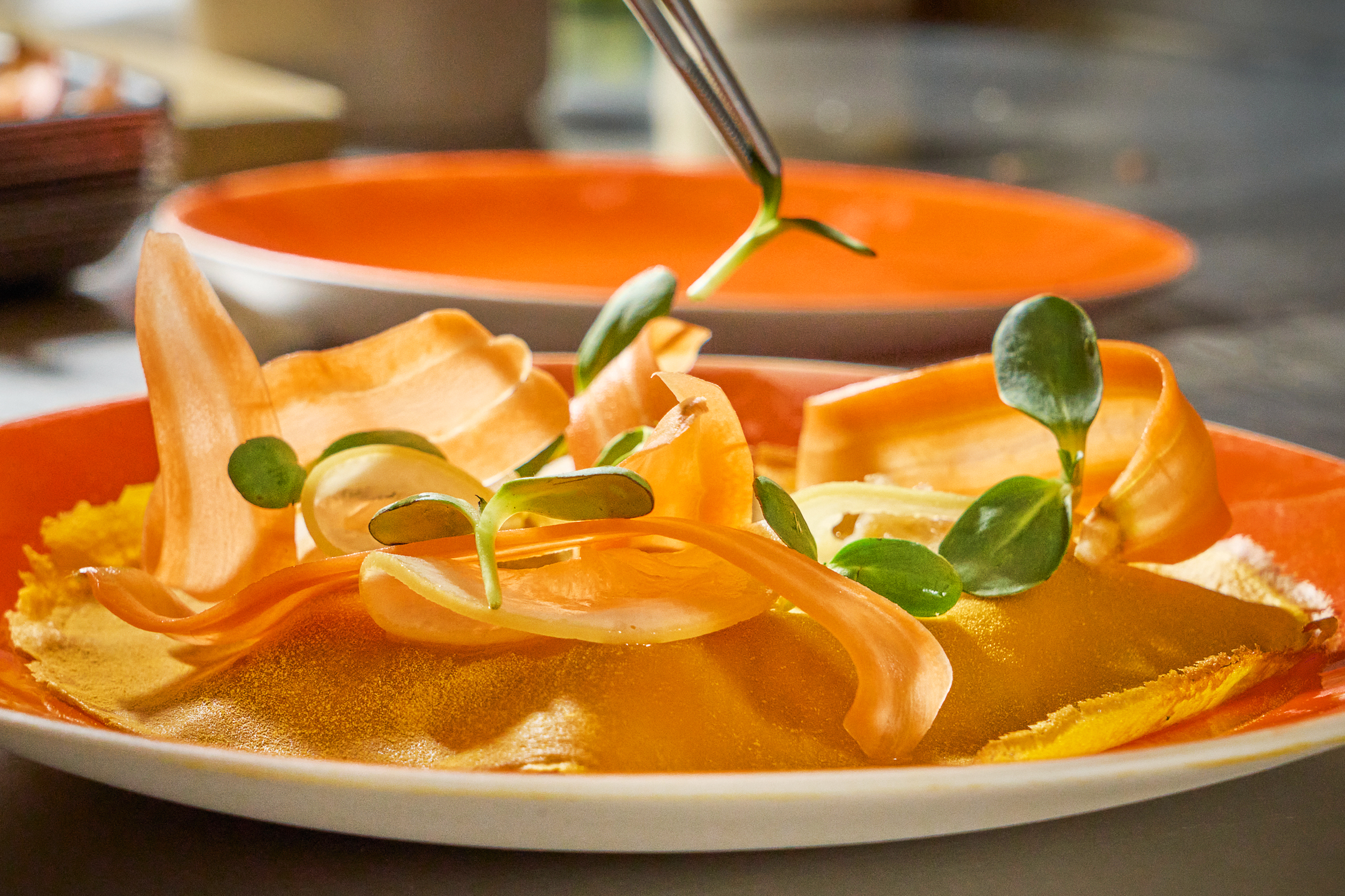 Orange crepes with orange petals on top.