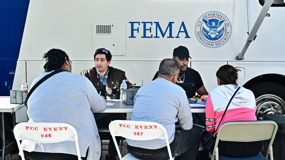 FEMA staffers sit in front of a branded truck.