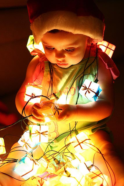 baby in christmas lights