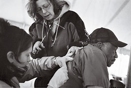 health care workers assist a patient